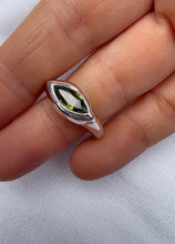 Load image into Gallery viewer, Silver ring with a green gemstone on a hand against a white background

