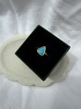 Load image into Gallery viewer, Turquoise stone in a black box on a textured white surface
