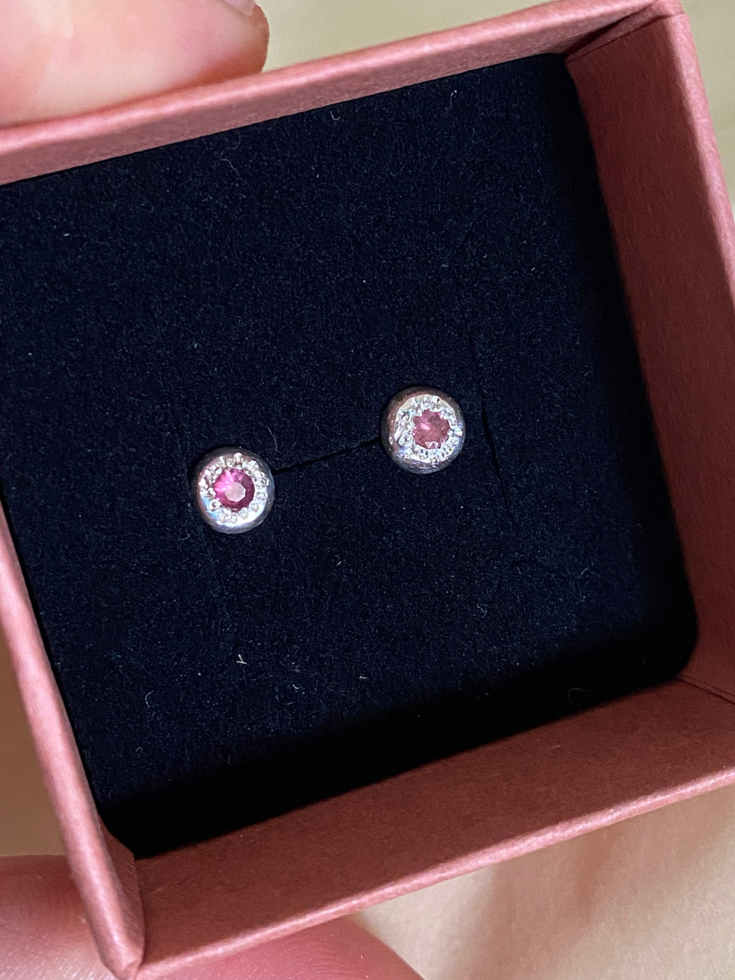 Watermelon Pink 2mm Gems set in to sterling silver stud earrings pictured in a velvet insert , in an opened jewellery box.